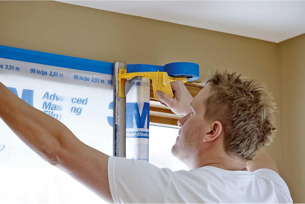 Man using 3M Hand-Masker M3000 to apply tape and film to door frame
