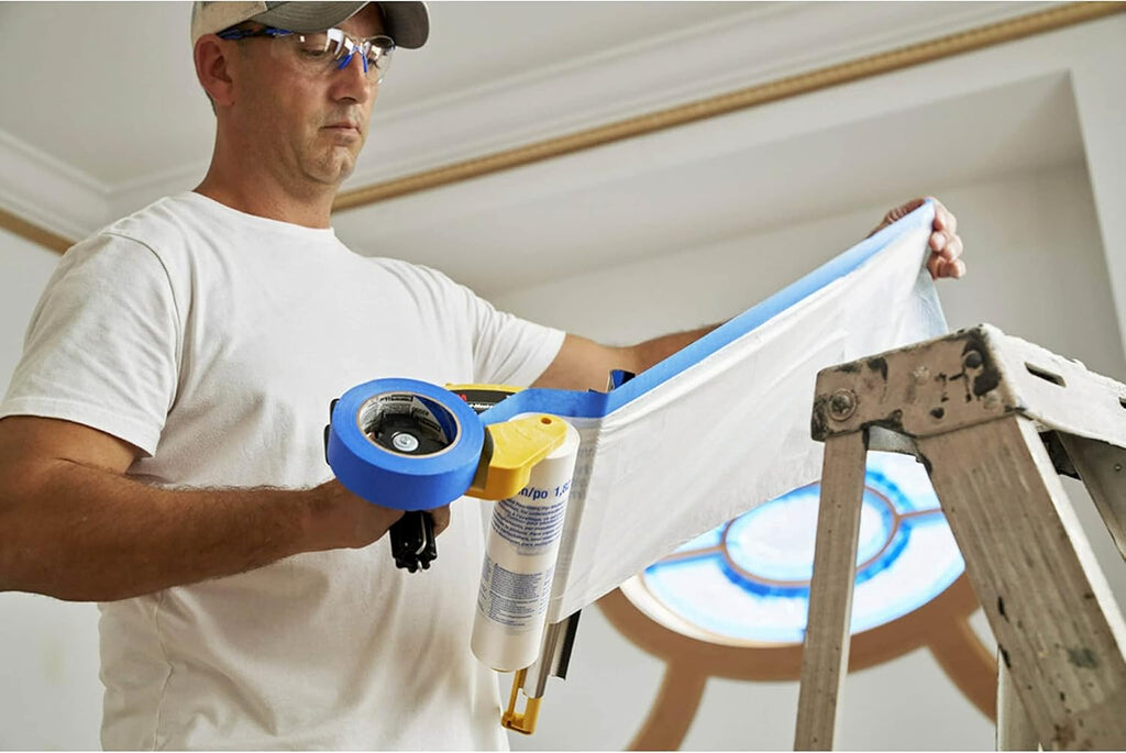 Professional painter checking masking film from 3M M3000 dispenser