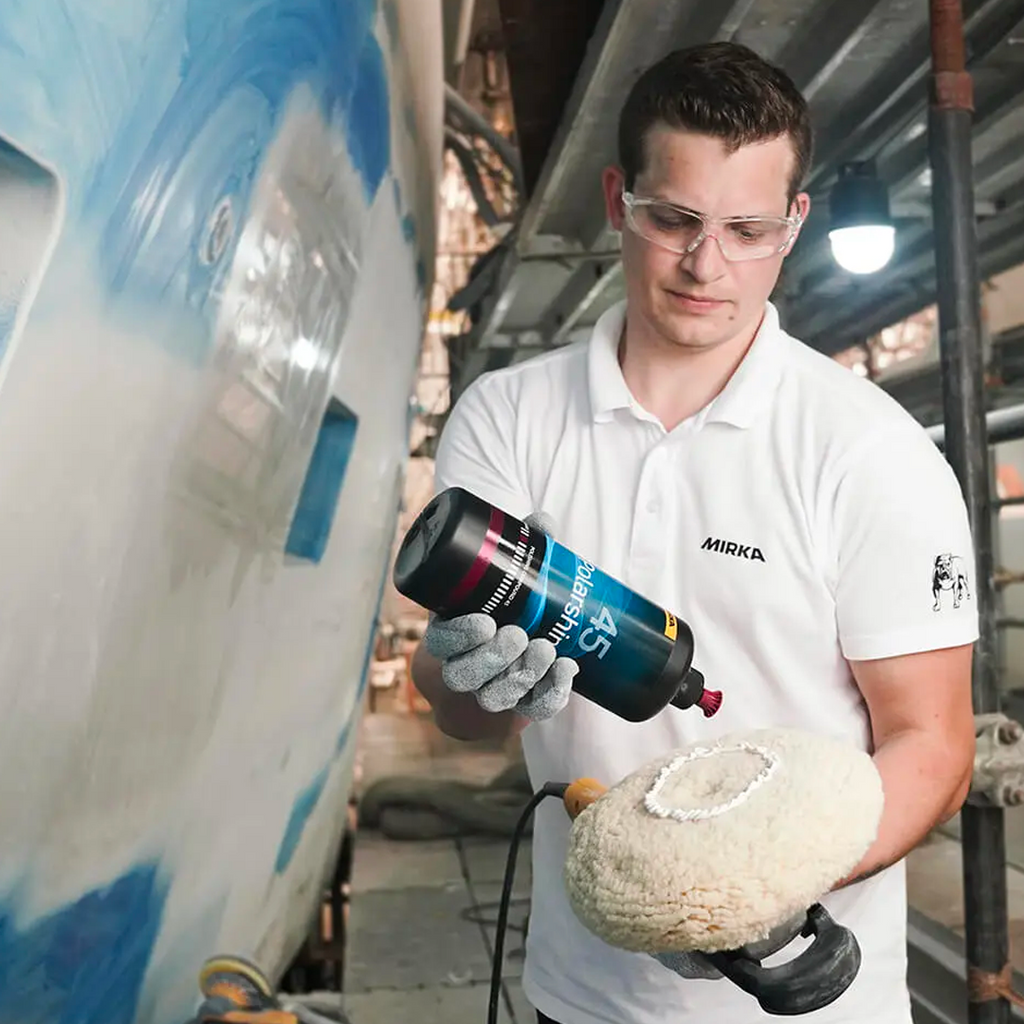 Tradie applying Mirka Polarshine 45 compound to a twisted wool pad for marine restoration