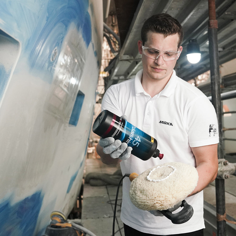 Tradie applying Polarshine 45 compound to a wool pad for heavy-duty industrial polishing