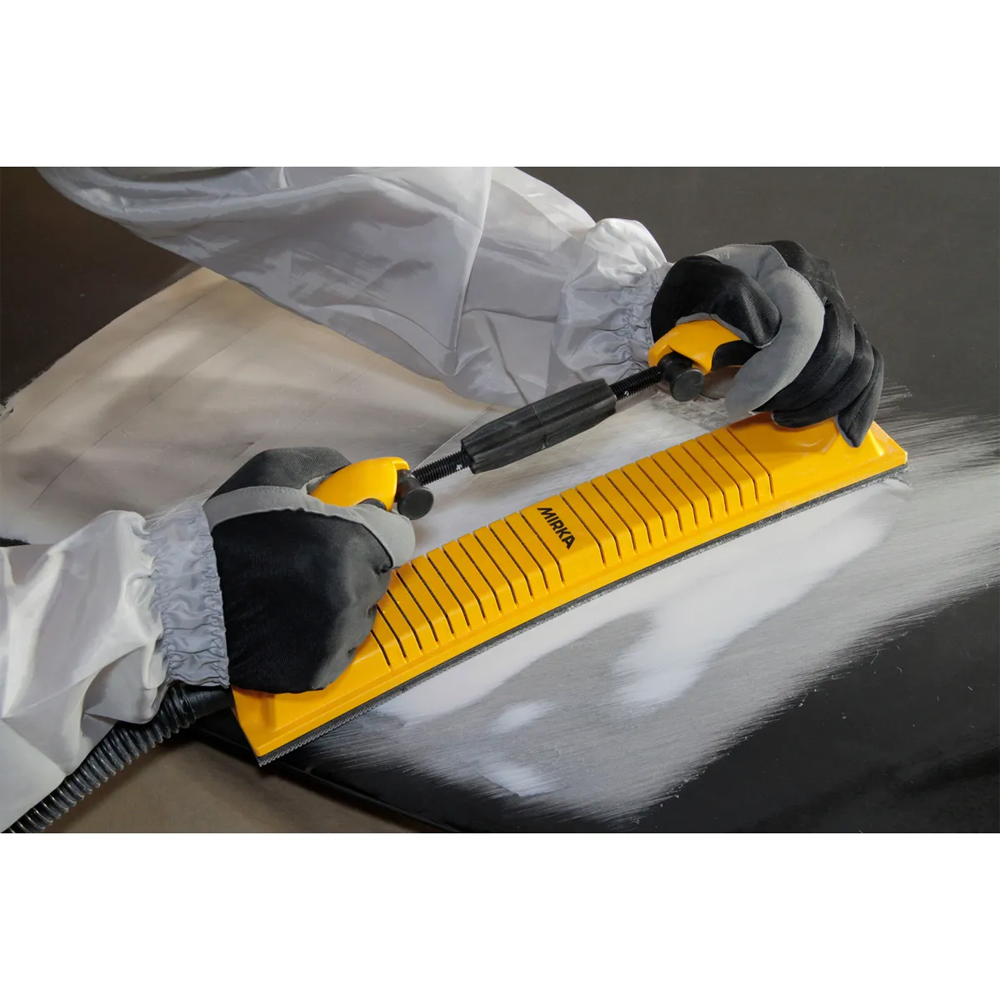 Tradie using an adjustable Mirka flexible file board to sand a curved surface
