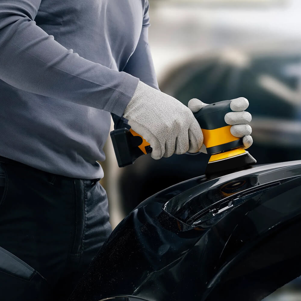 Detailing a car bumper with the Mirka cordless rotary polisher for precise finish