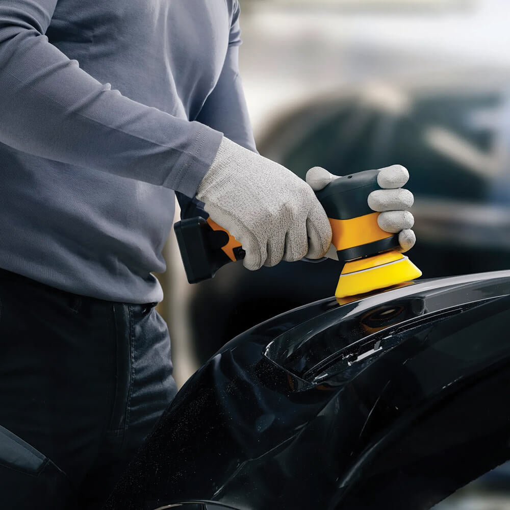 Detailing a car bumper with the Mirka cordless rotary polisher for precise finish