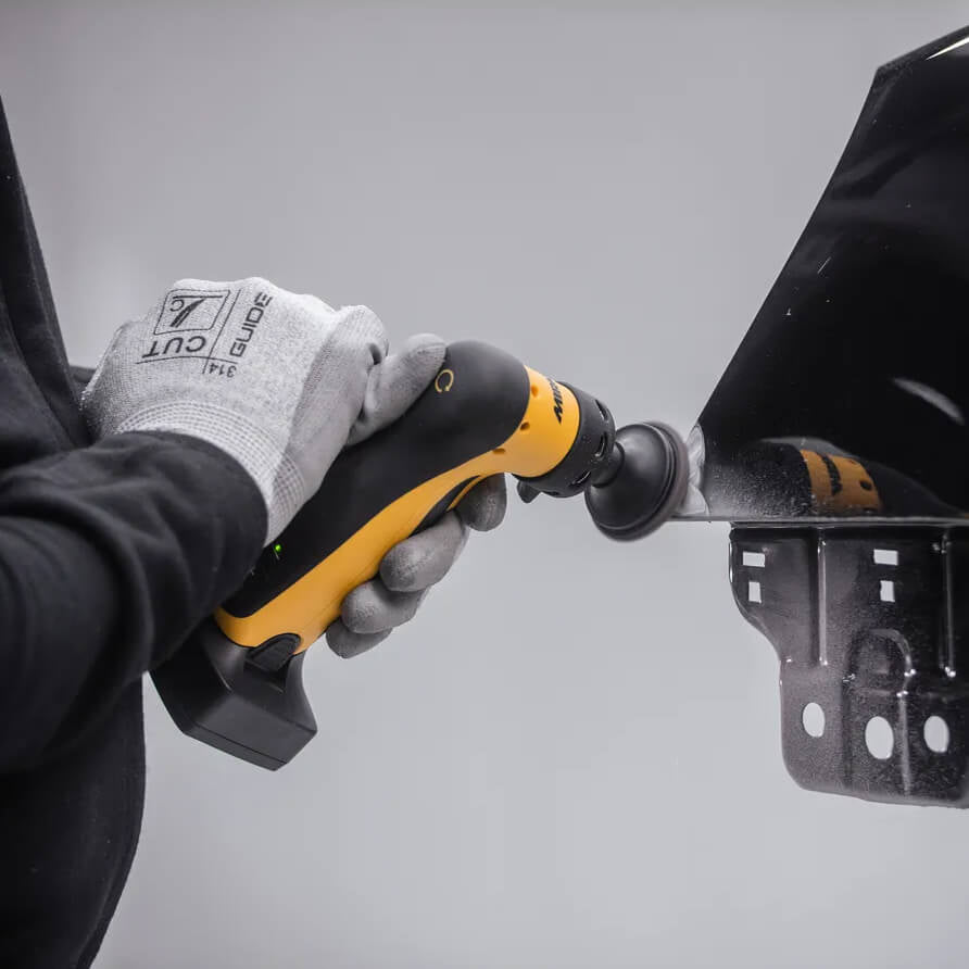 Tradie using a Mirka ANGOS cordless grinder for precision metal deburring