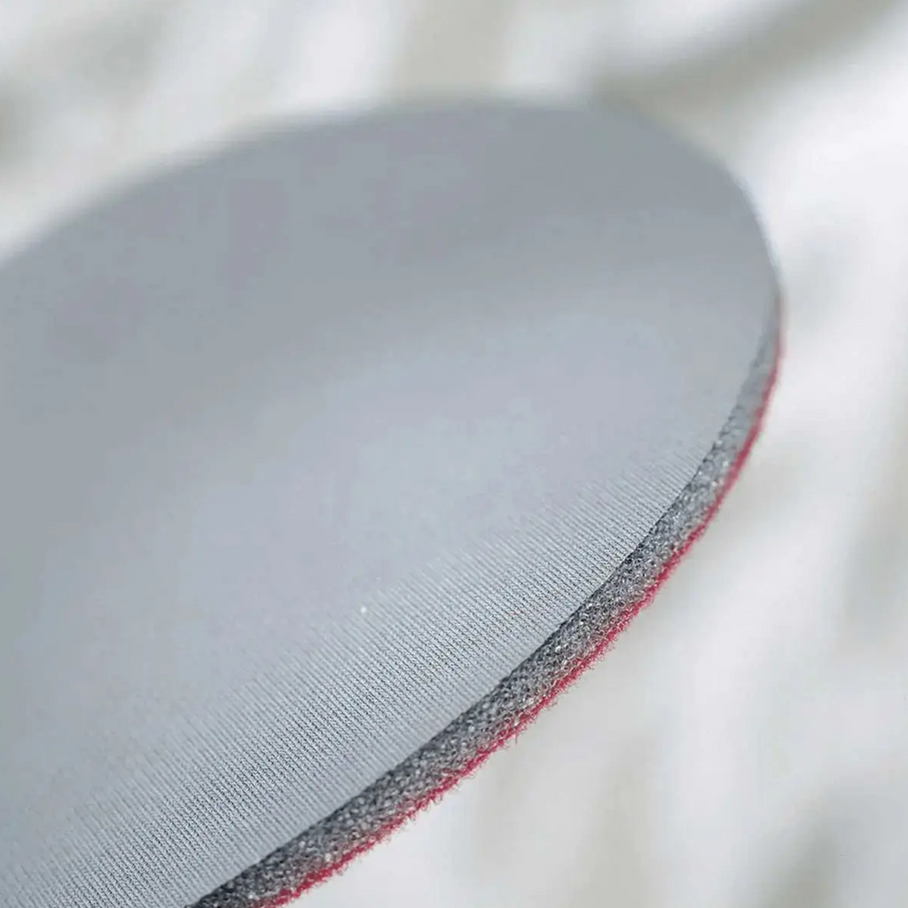 Close-up of the 6.5mm thick foam backing on a Mirka Abralon disc for contoured surfaces