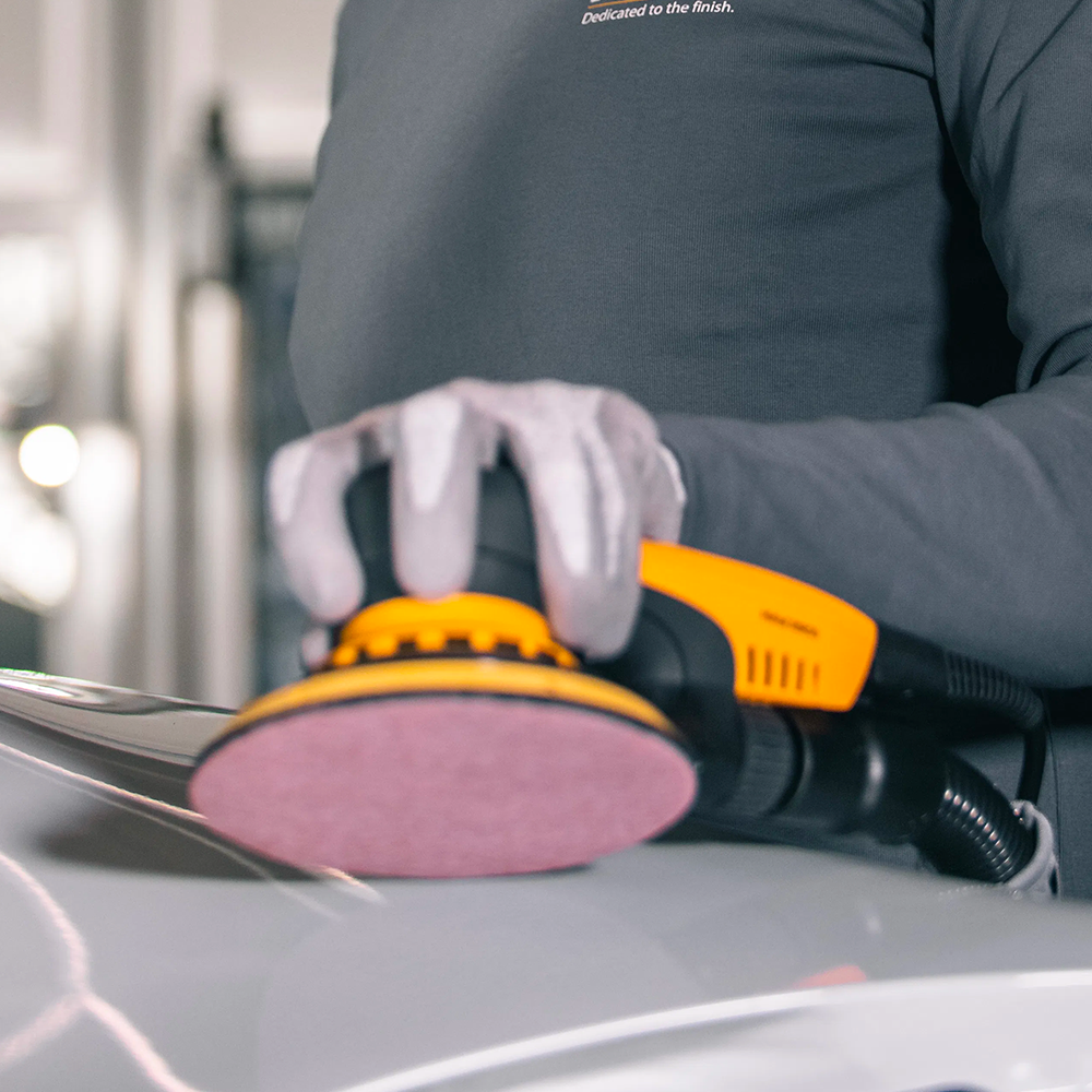 Detailed view of a Mirka ceramic net disc being used for high-performance surface prep