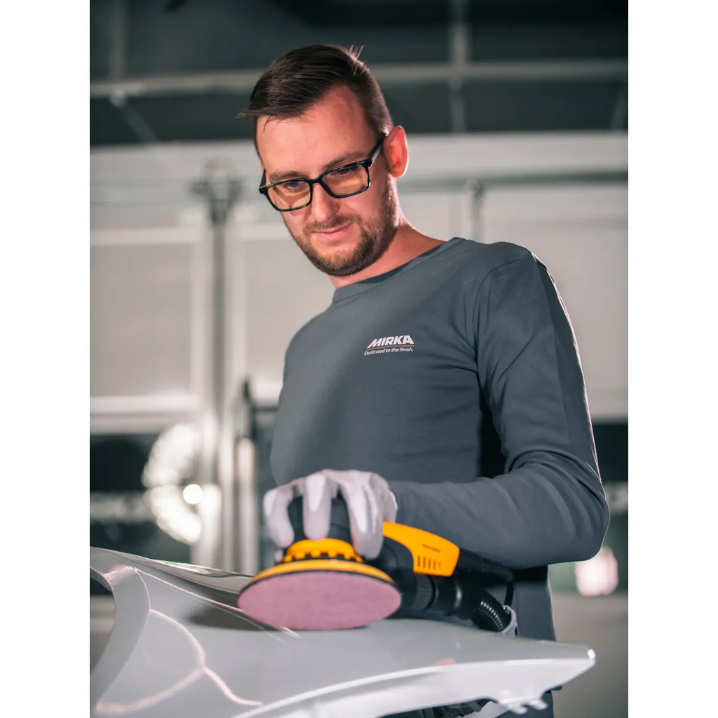 Professional using a 150mm Mirka sander for automotive paint prep on a car panel