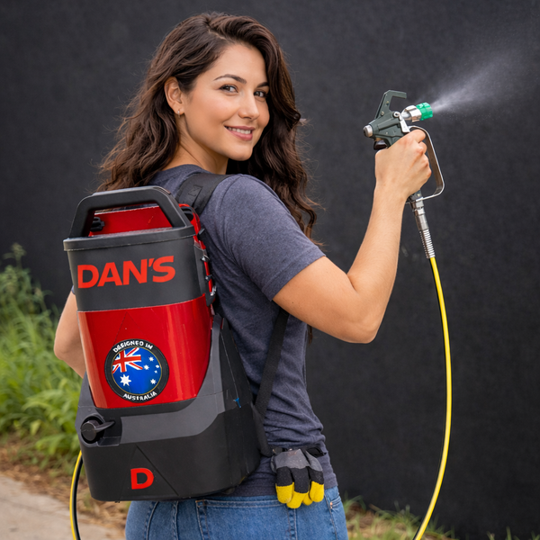 Woman using an airless backpack sprayer with 'DAN'S' branding outdoors.