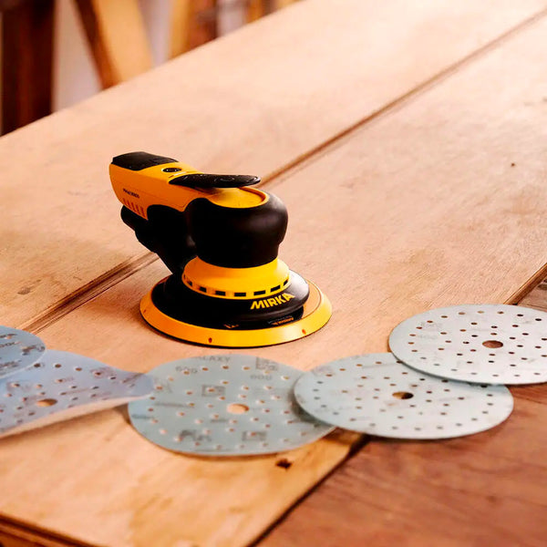 Mirka DEROS sander alongside multiple blue Multifit Galaxy discs for timber sanding