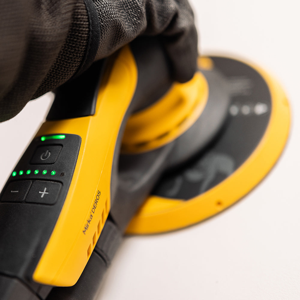 Close-up of a worker sanding with the lightweight and low-profile Mirka DEROS II 750